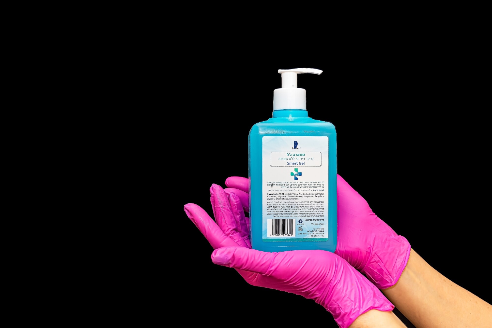 Woman with pink gloves hold sanitizer bottle